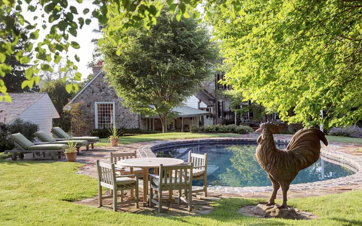 Stone Farmhouse Exterior with a pool