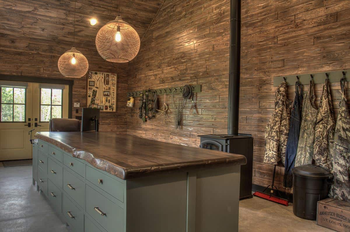 farmhouse style hunting gear storage room with a fireplace stove