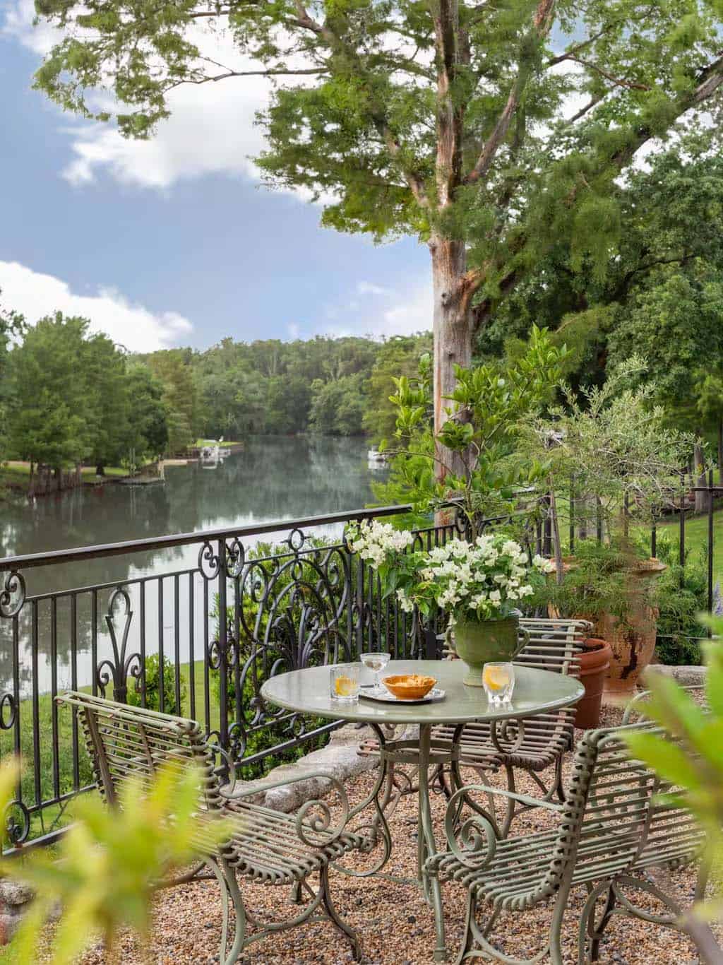 provencal-inspired home exterior patio with a bistro set overlooking the river