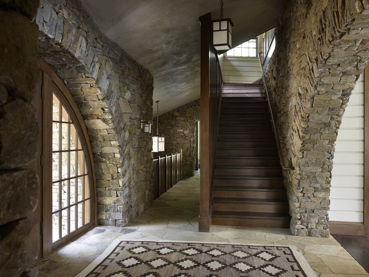 rustic lake house entry with a staircase leading upn to the second level