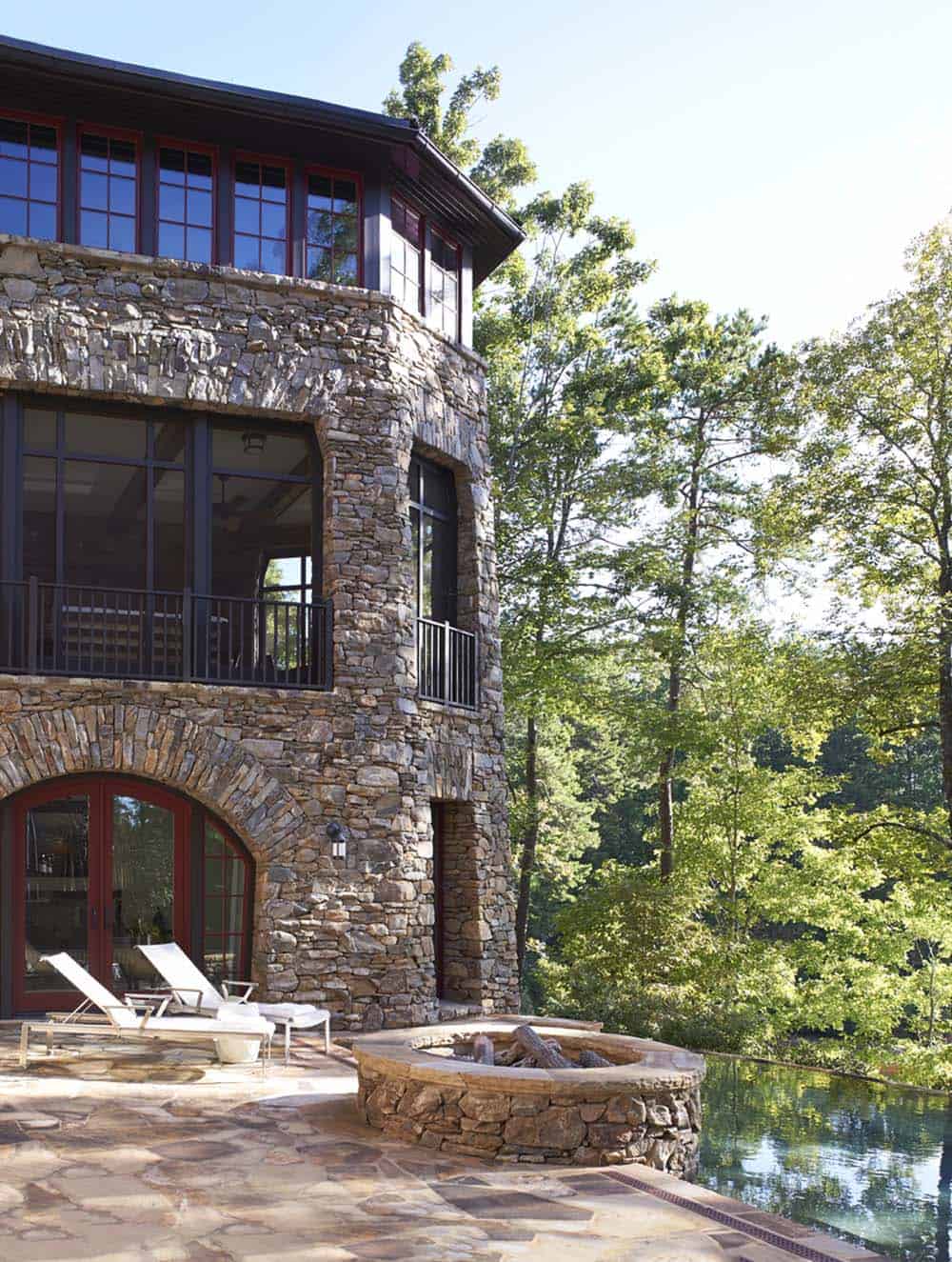 rustic craftsman-style lake house patio with a firepit and swimming pool