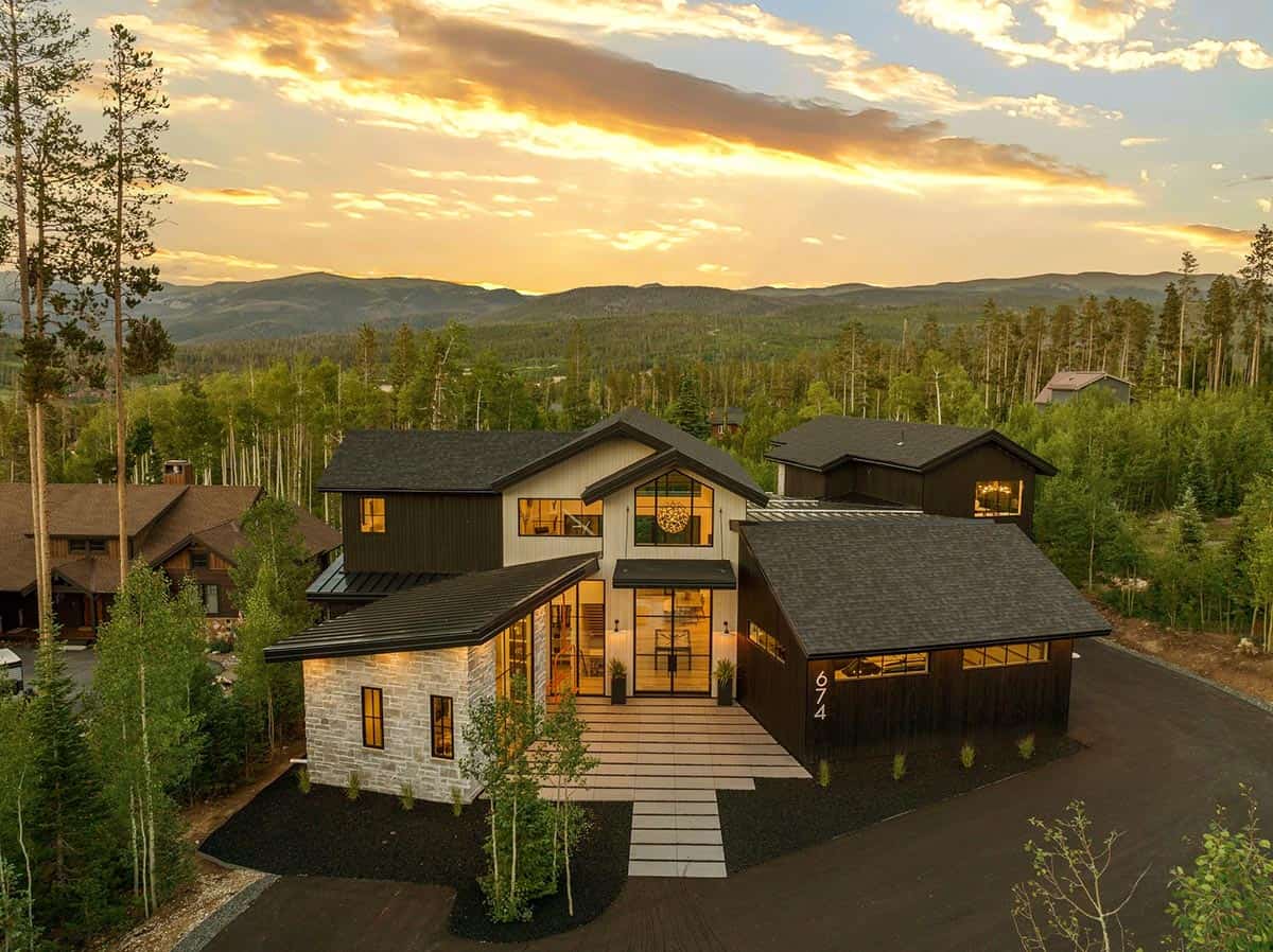 scandinavian mountain home exterior with a sunset