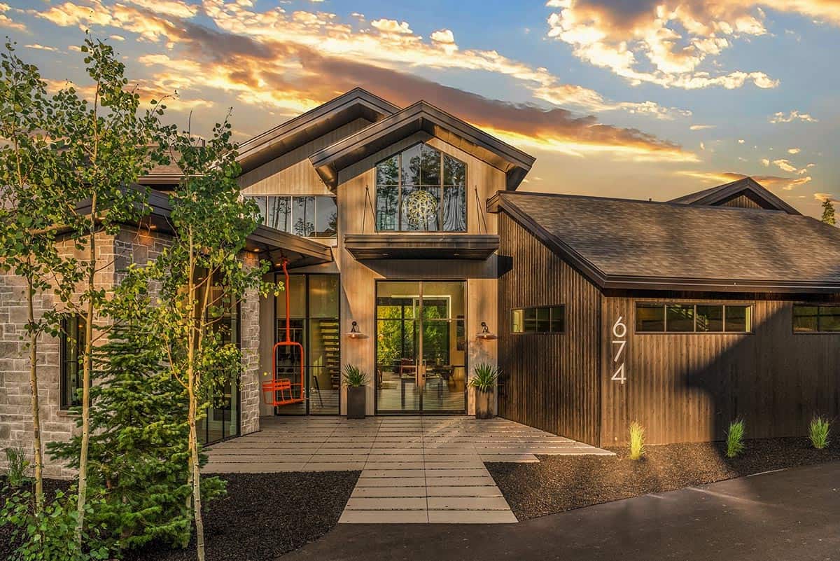 scandinavian mountain home exterior with a sunset