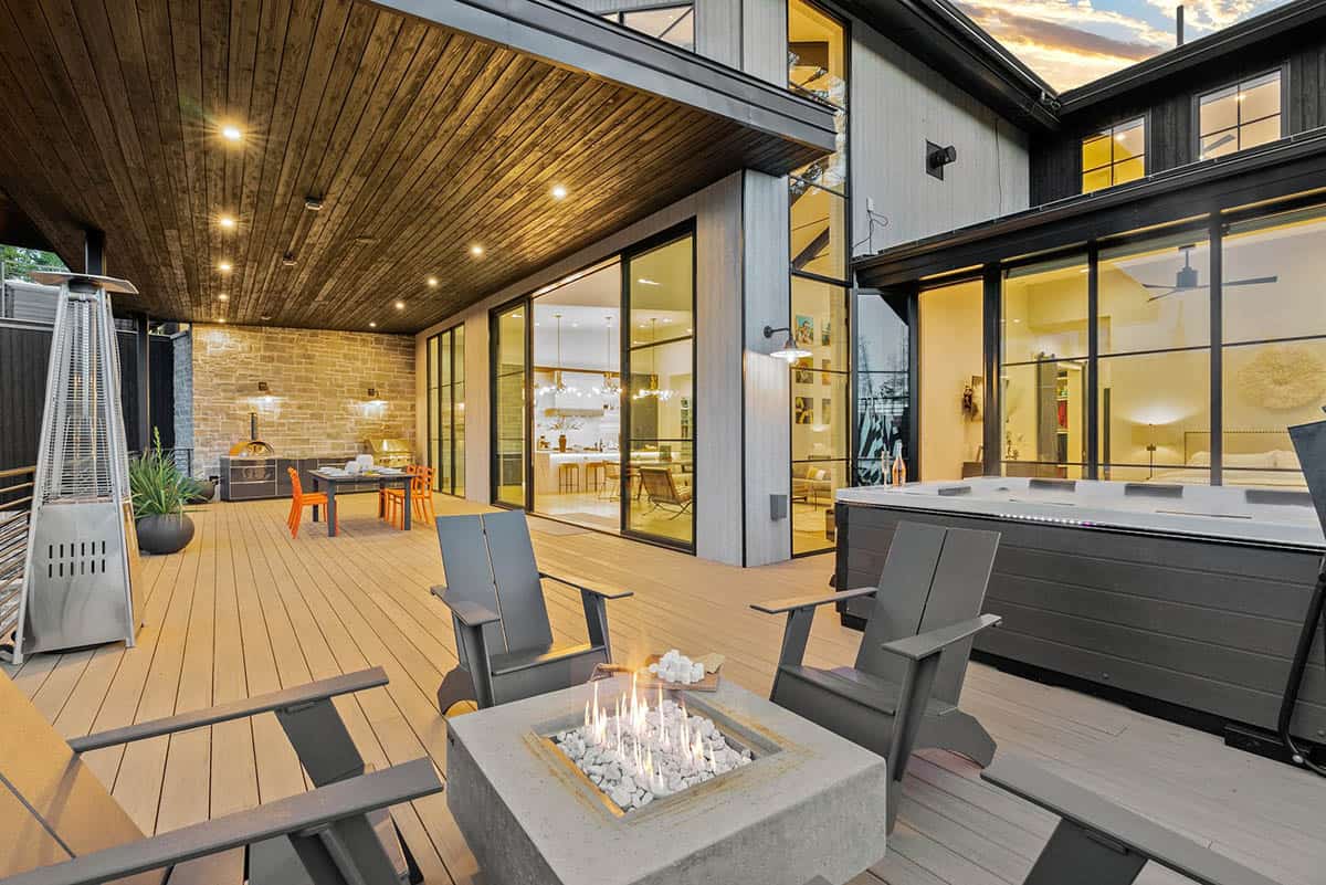 scandinavian mountain home exterior with a patio and fire pit