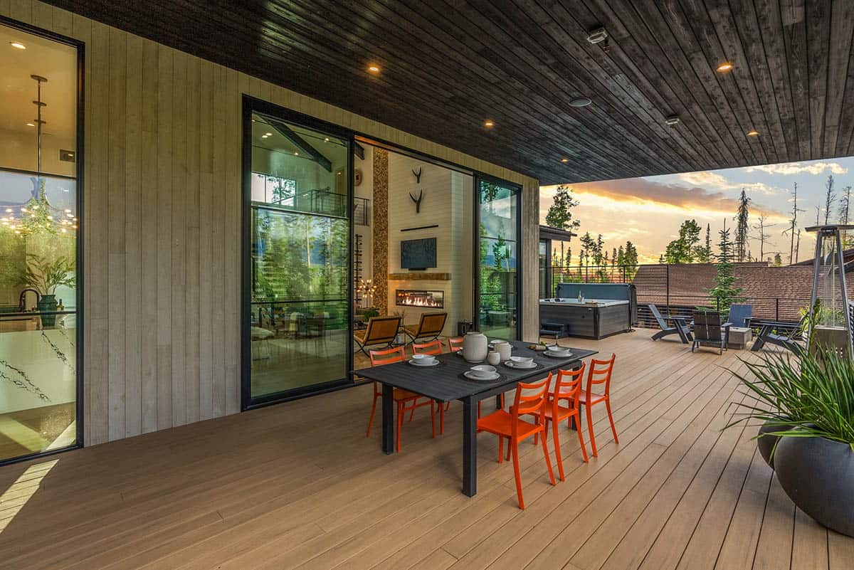 scandinavian mountain home exterior with a covered patio and outdoor dining