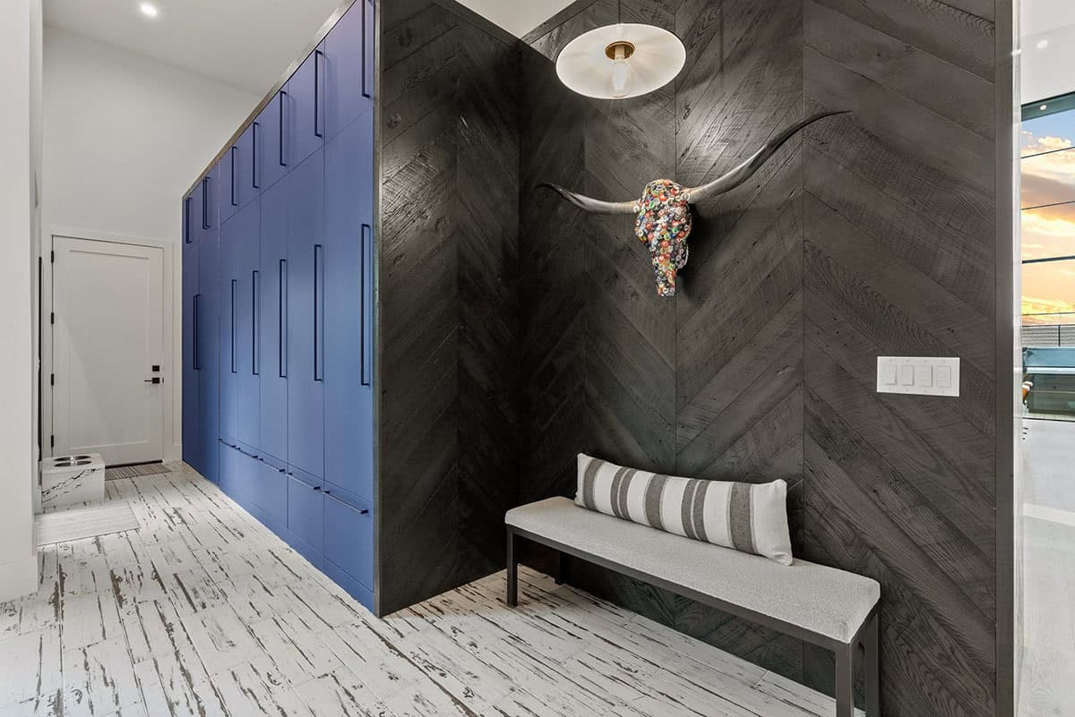 scandinavian mountain home mudroom with storage lockers and a bench