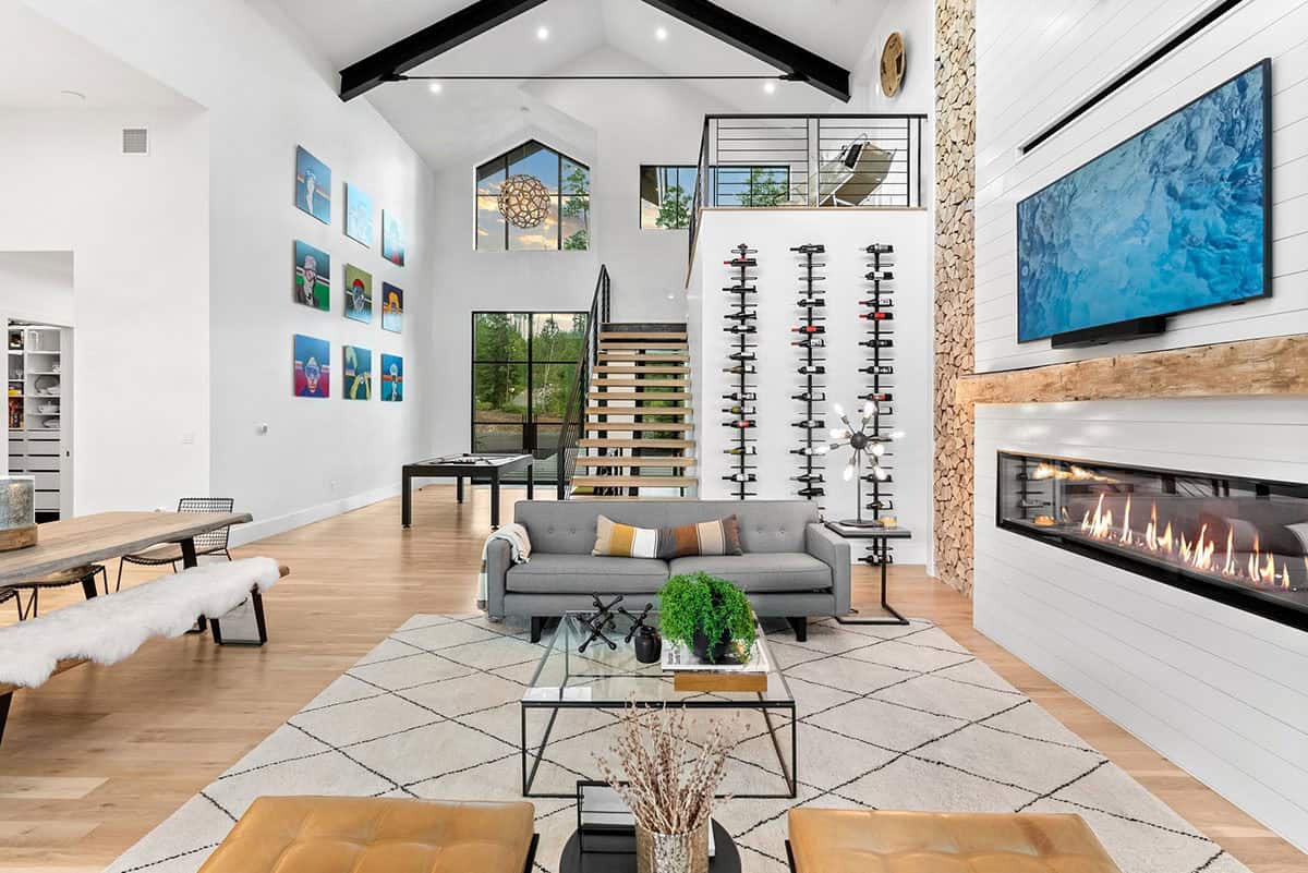 scandinavian modern living room with a wine cellar wall