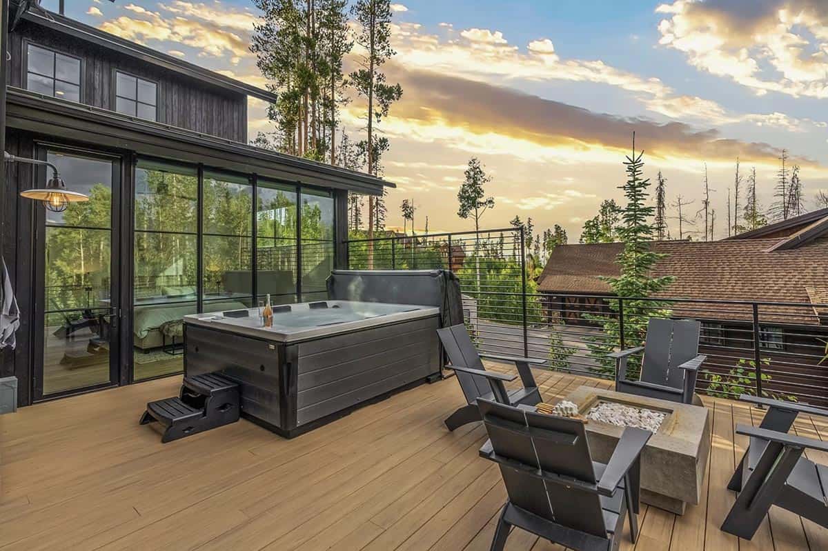 scandinavian mountain home exterior patio with a hot tub