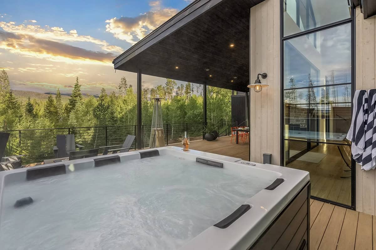 scandinavian mountain home exterior patio with a hot tub