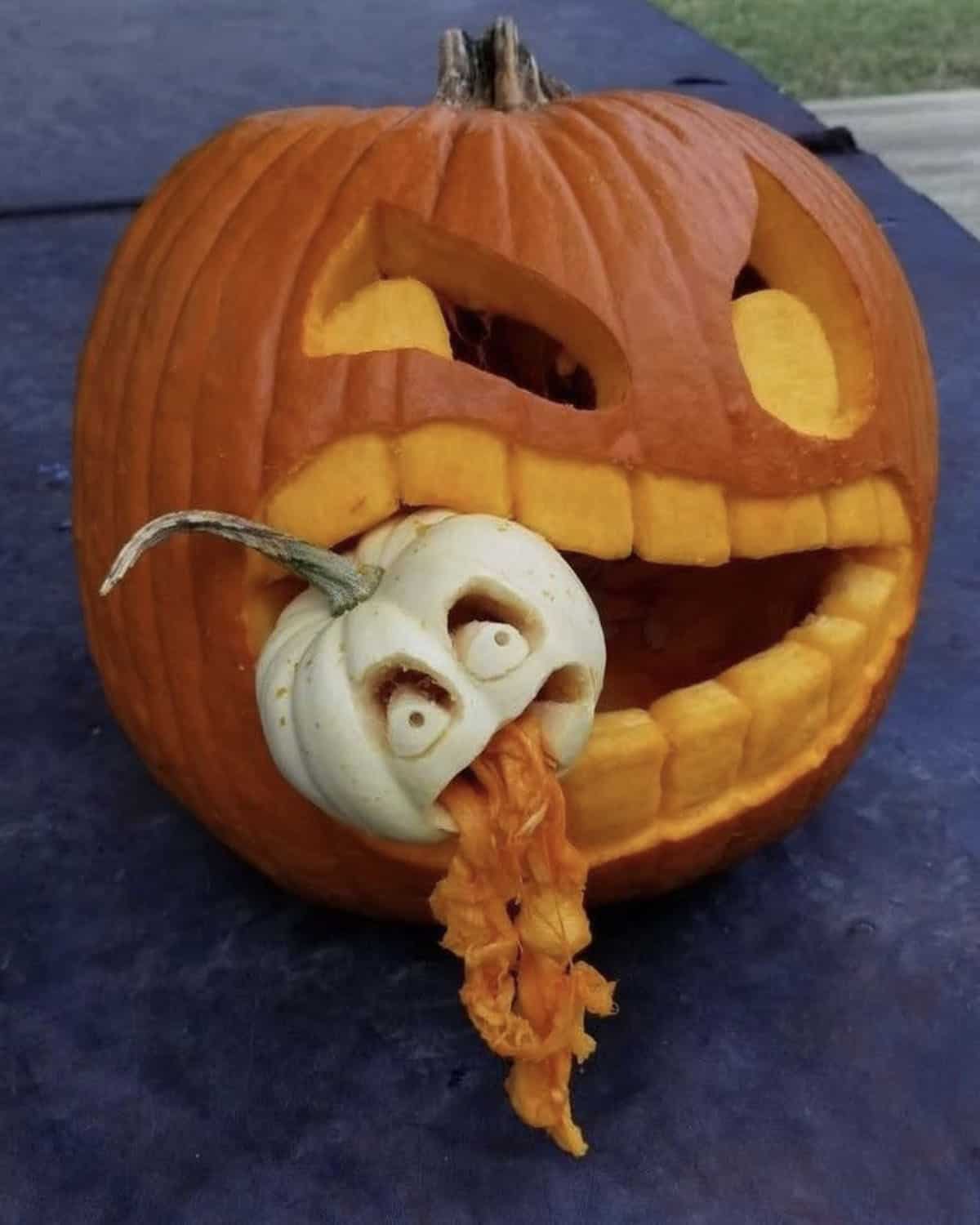 big pumpkin eating a little pumpkin