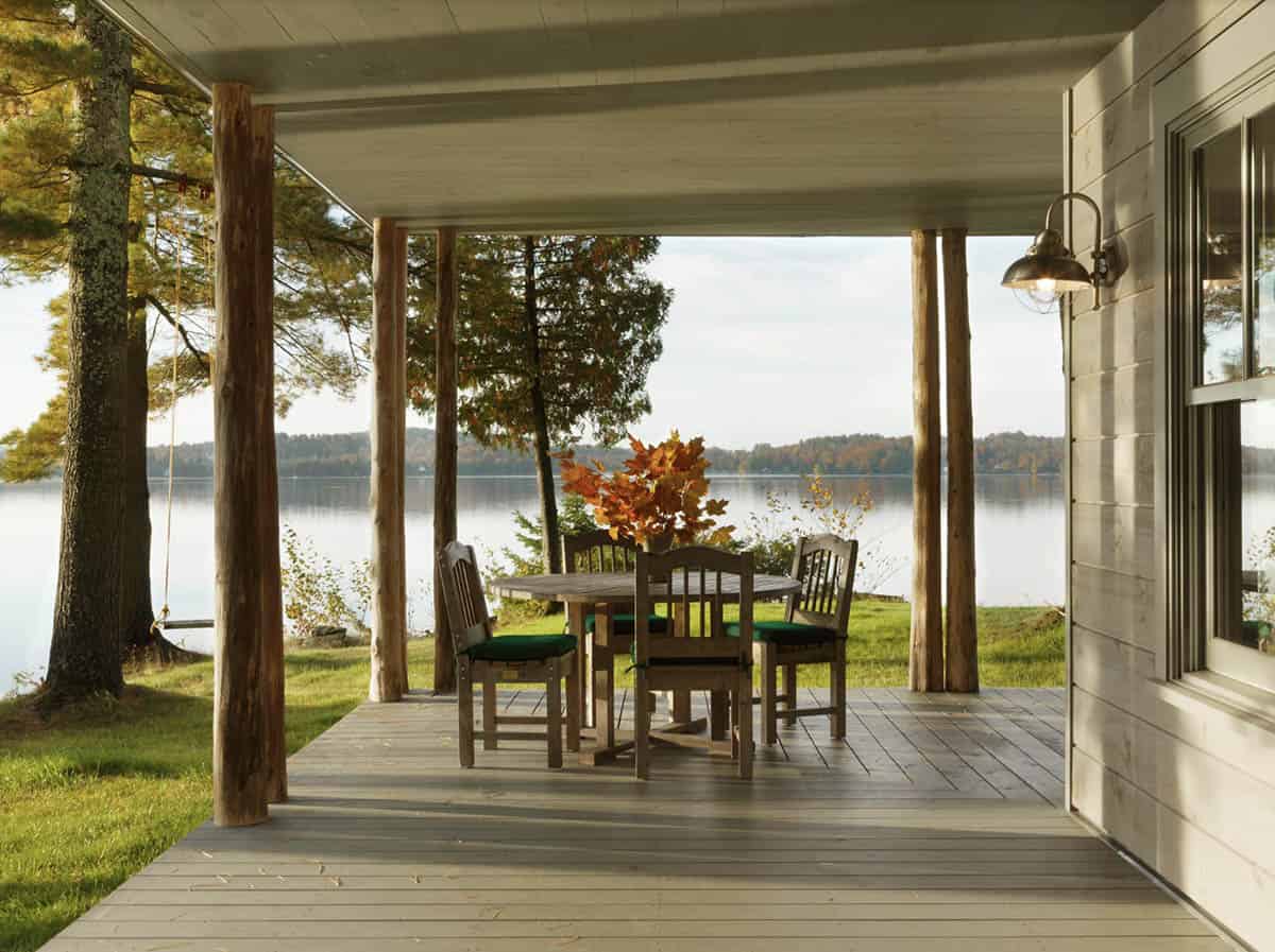 lake house exterior with a covered porch and alfresco dining