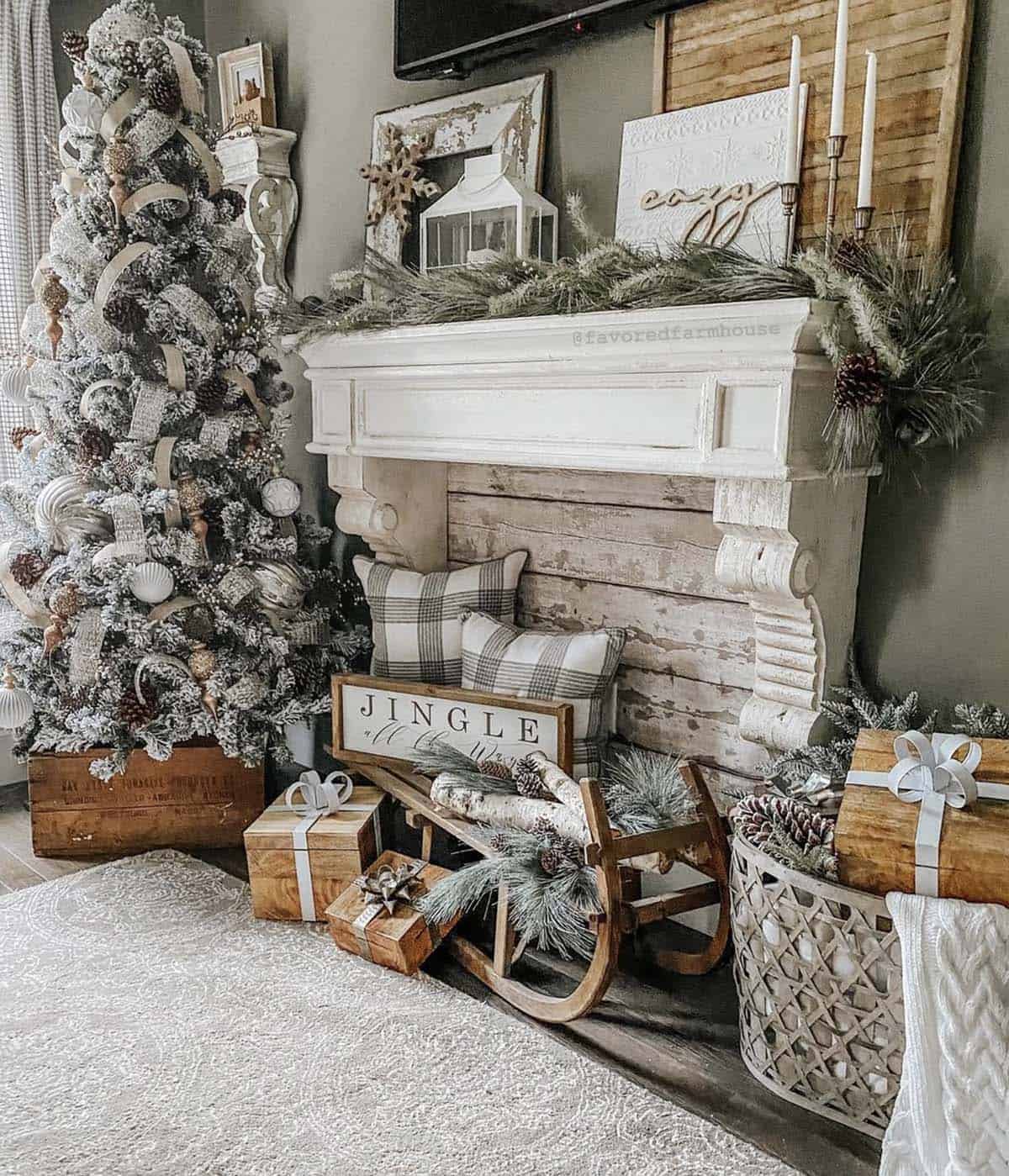 flocked christmas tree next to a fireplace mantel in the living room