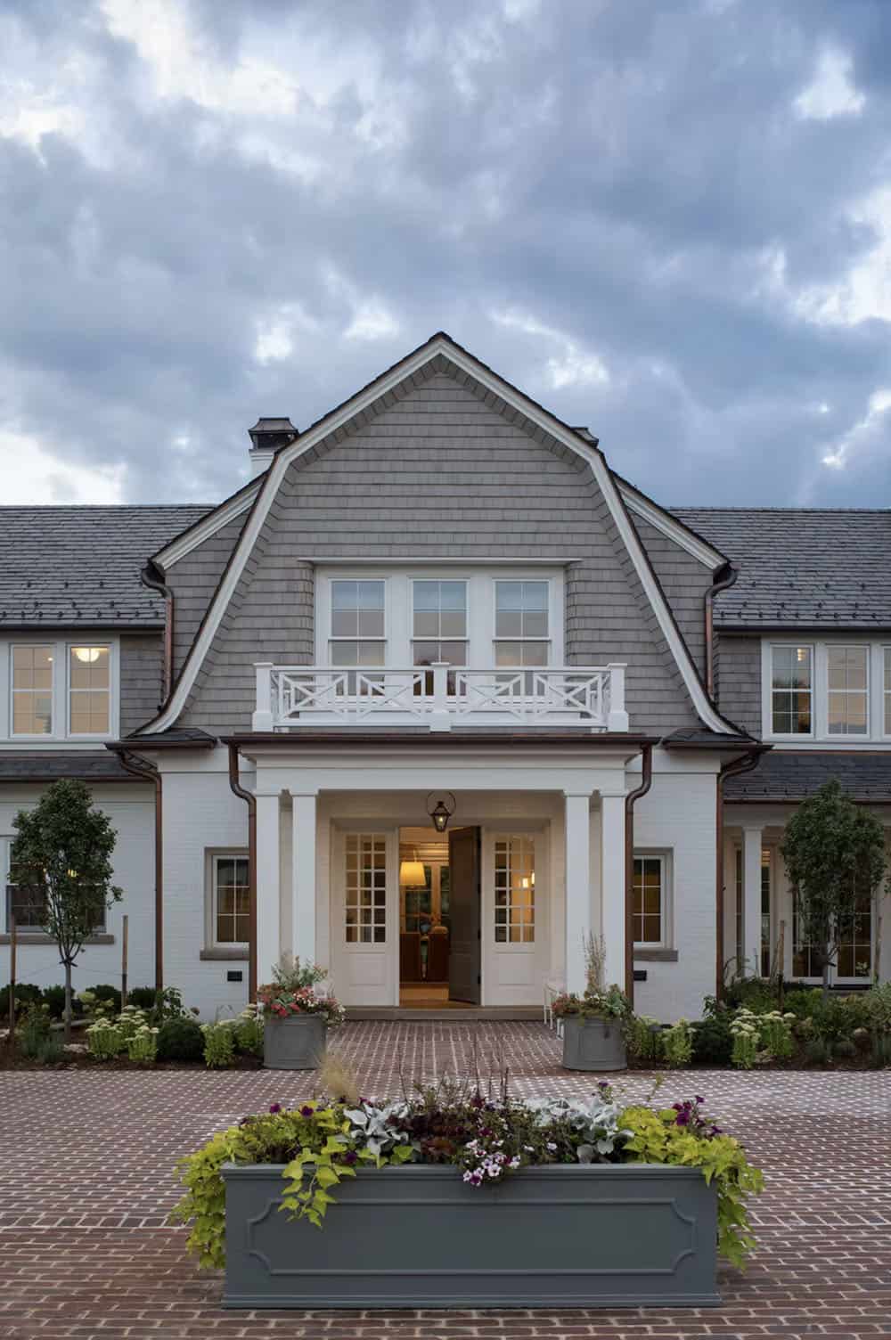 cape-cod inspired home exterior with a gambrel roof