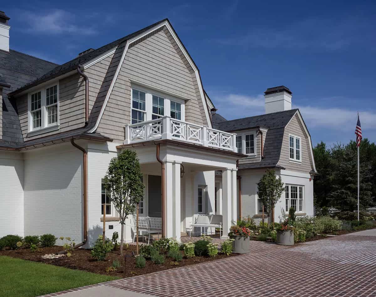 cape-cod inspired home exterior with a gambrel roof
