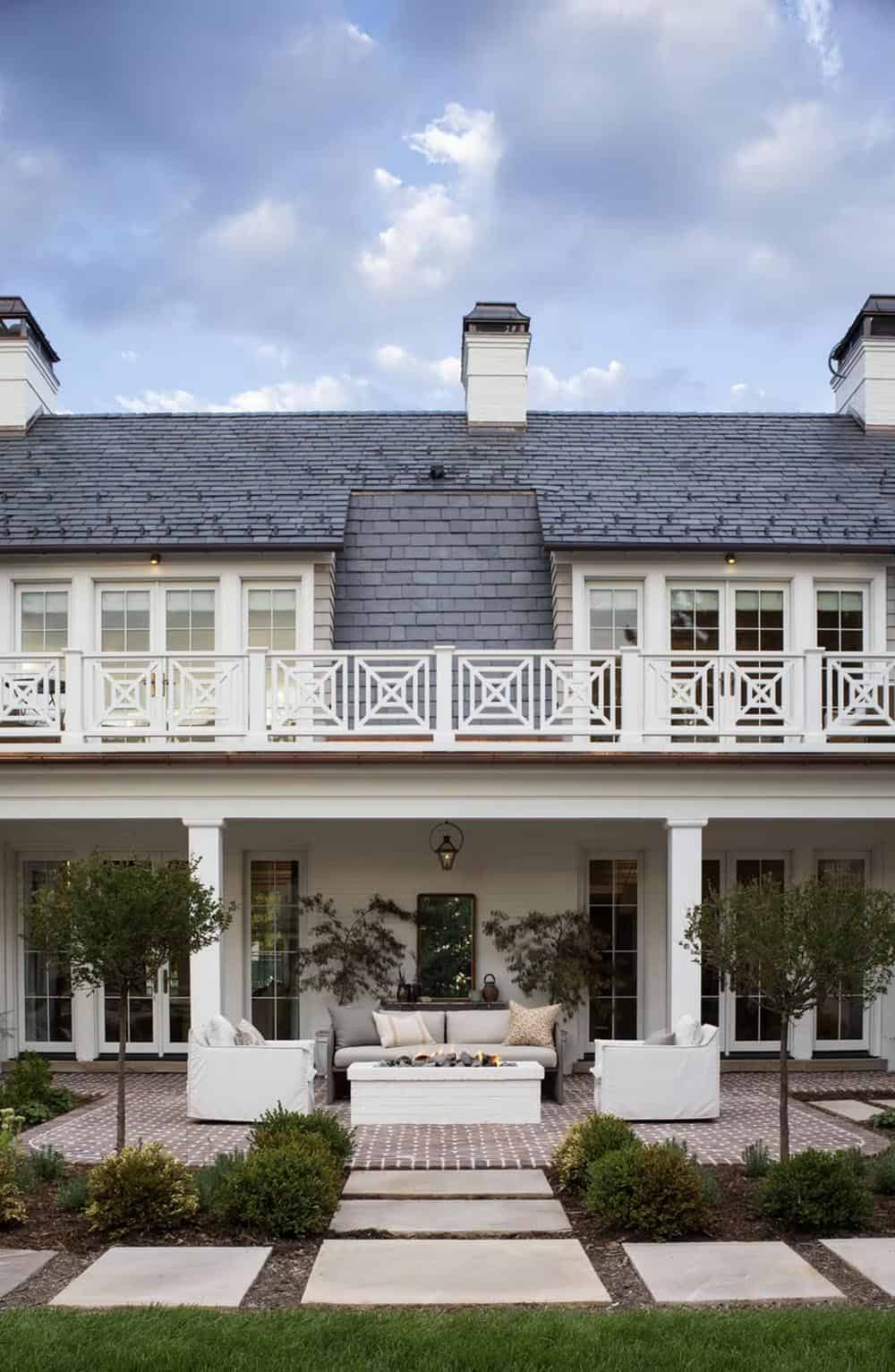 cape-cod inspired home exterior backyard with a patio