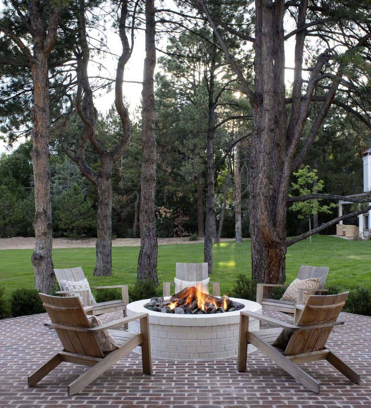 cape-cod inspired home exterior with a patio and fire pit
