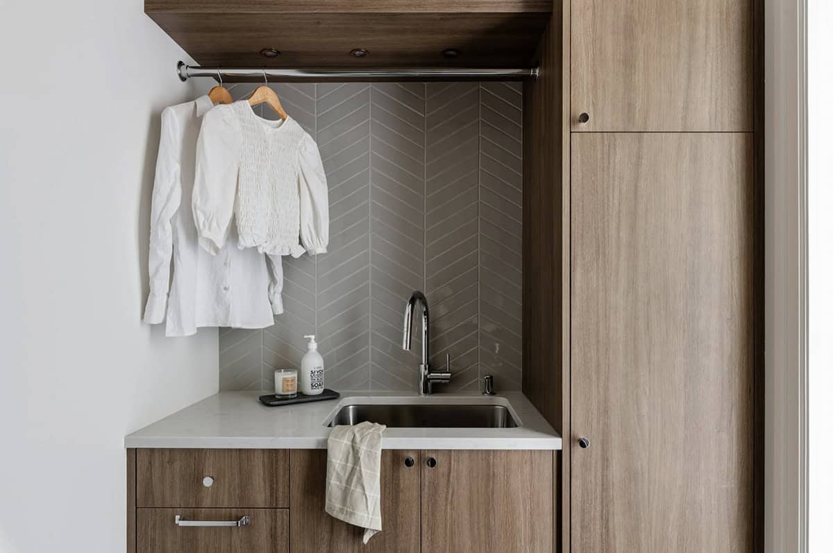 transitional style laundry room with a sink