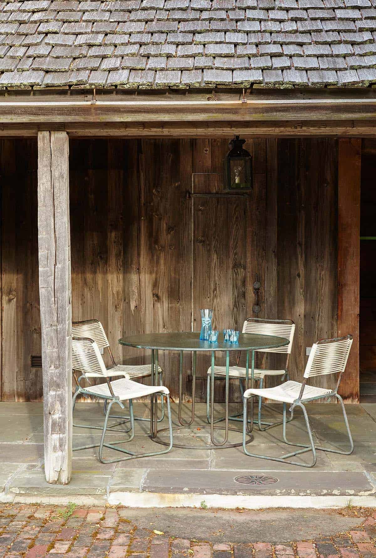 colonial farmhouse style home exterior with a covered patio