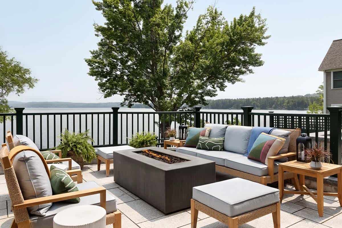 contemporary lake house exterior with a patio and fire pit