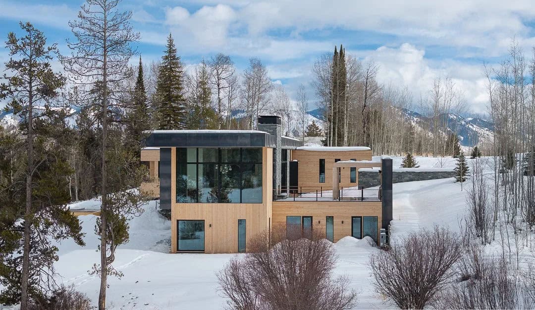 contemporary mountain house exterior with snow