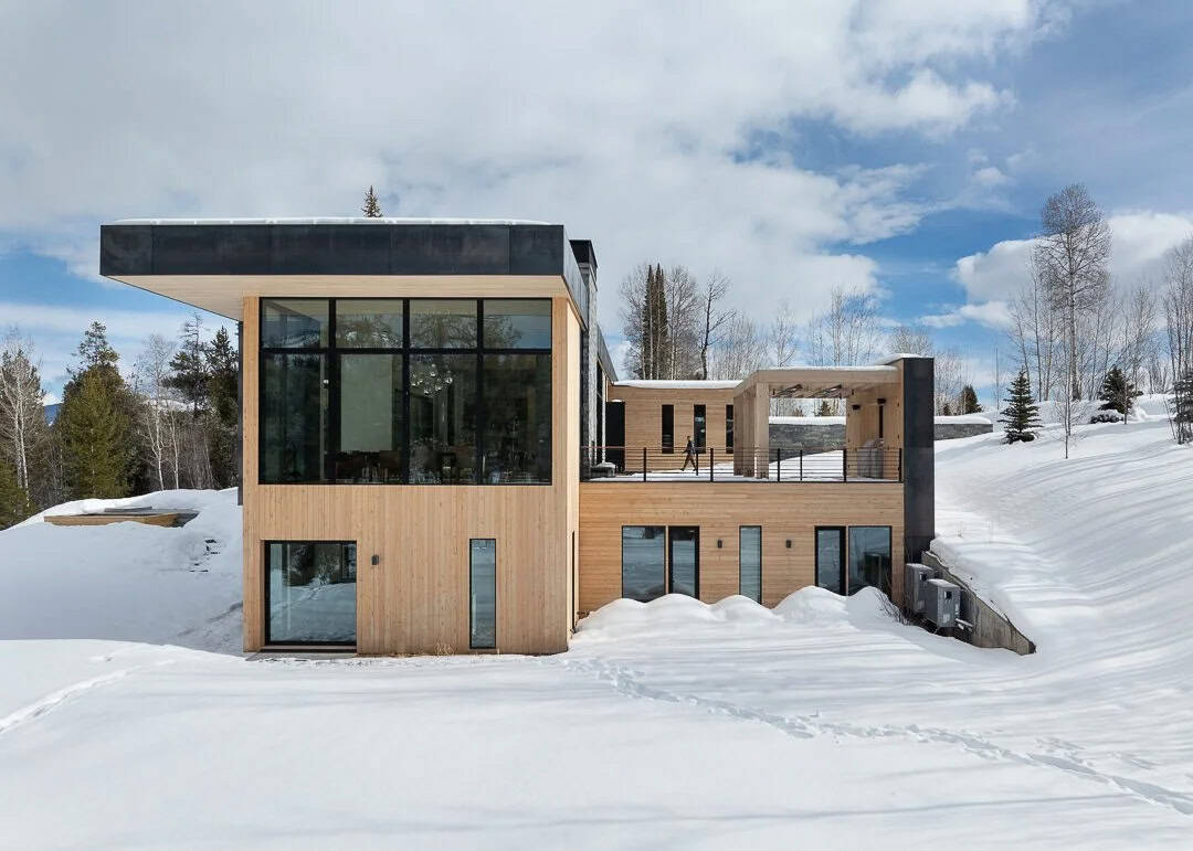 contemporary mountain house exterior with snow