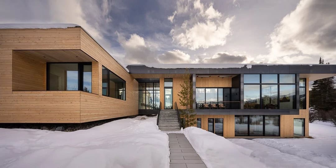 contemporary mountain house exterior with snow