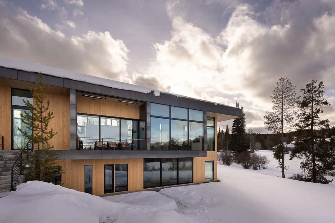 contemporary mountain house exterior with snow