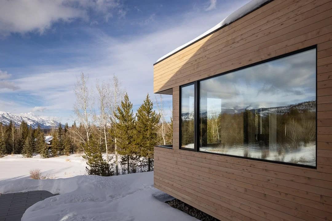 contemporary mountain house exterior with snow