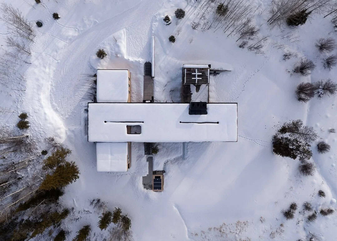 contemporary mountain house exterior with snow aerial view
