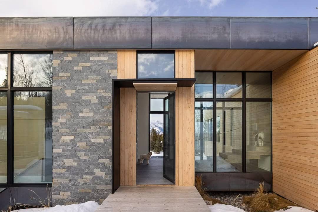 contemporary mountain house exterior entry with snow