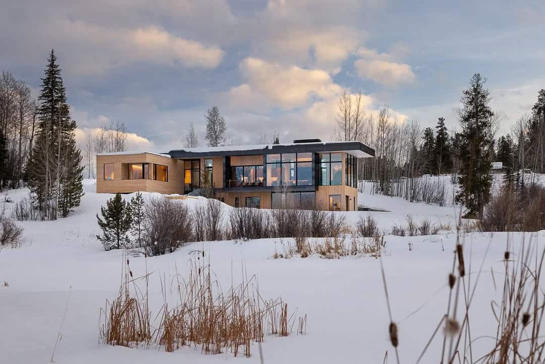 contemporary mountain house exterior with snow