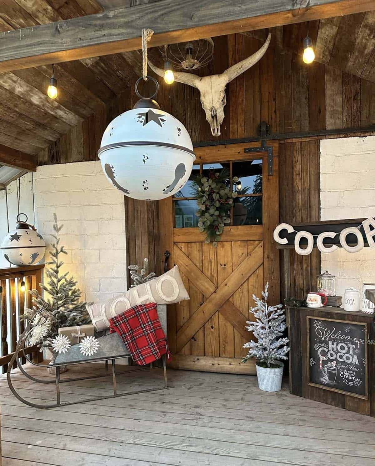 christmas decorated front porch with oversized ornaments