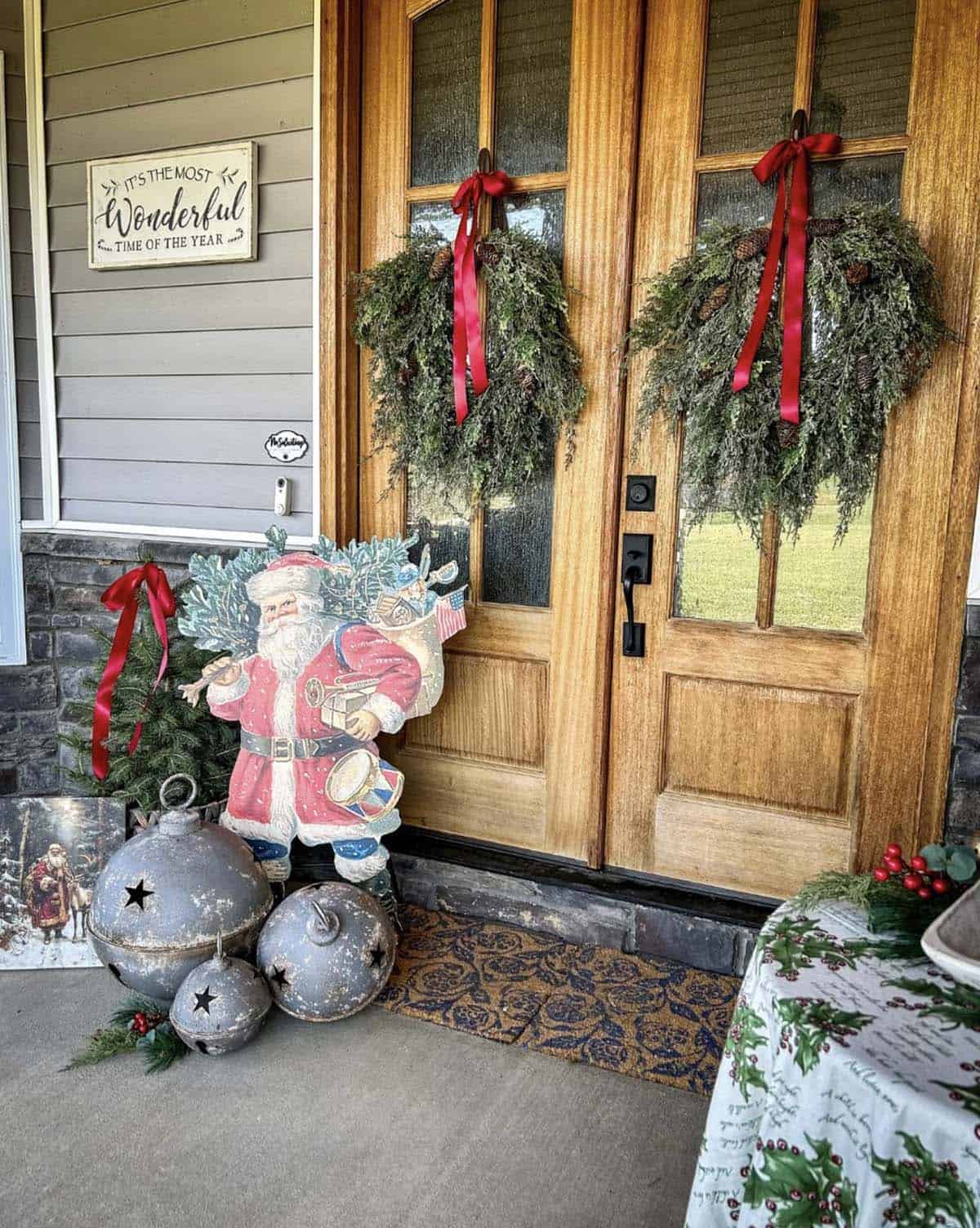 christmas decorated front porch with door wreaths