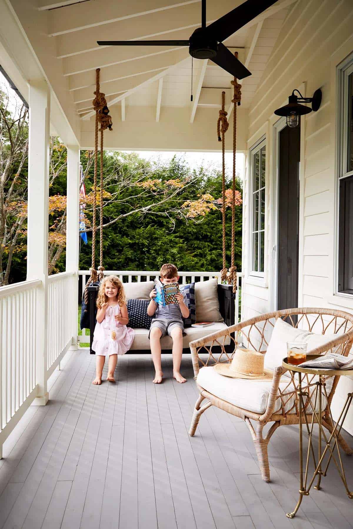 farmhouse style covered balcony with a hanging daybed