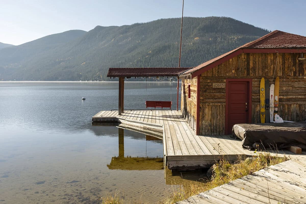 rustic lake house exterior with a view of the water