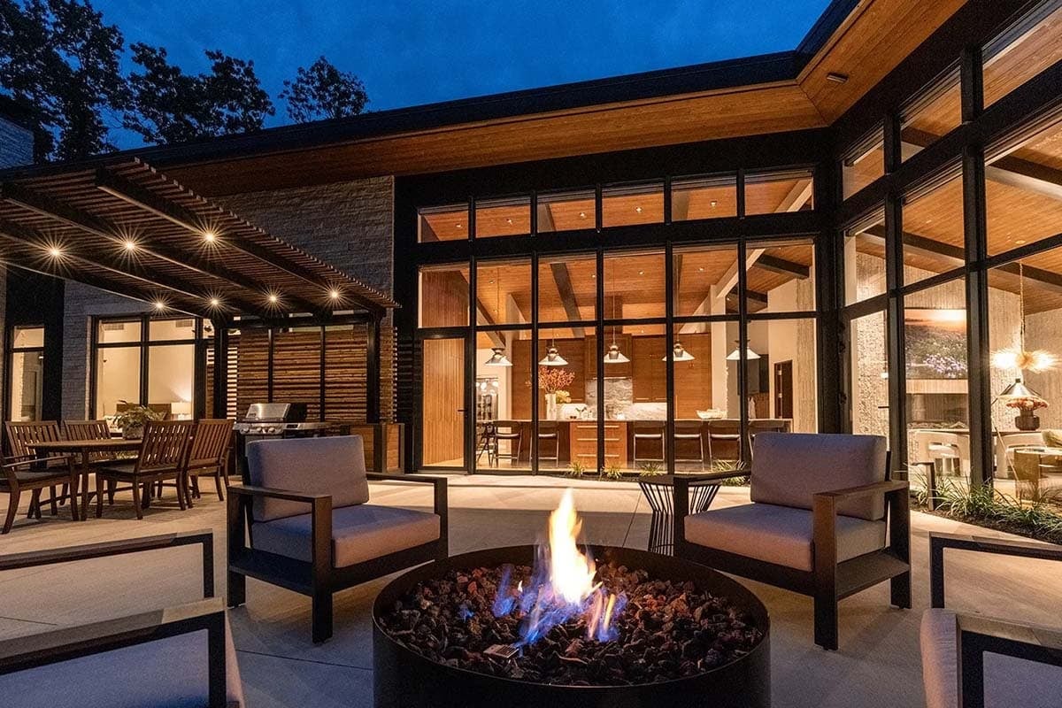 midcentury modern home exterior patio with outdoor furniture and a fire pit