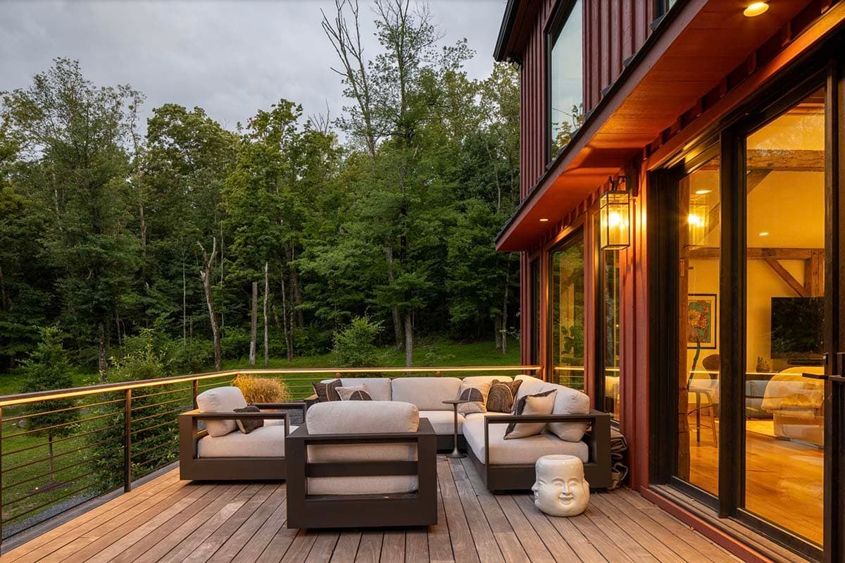 barn house exterior with a deck and outdoor furniture