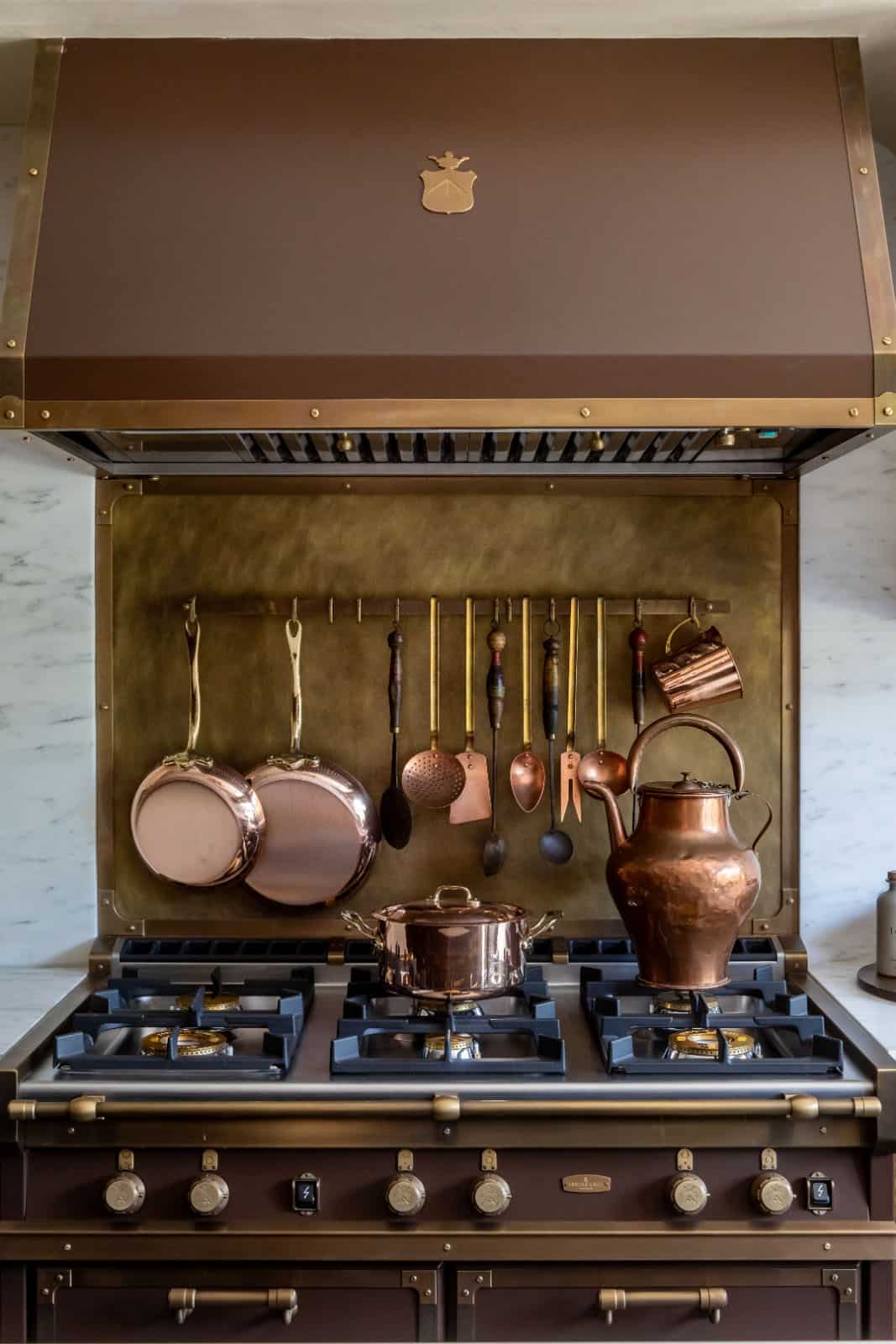modern kitchen stove detail with copper pots