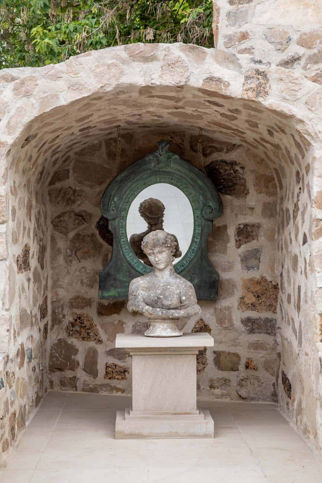 modern home exterior with a statue on a pedestal