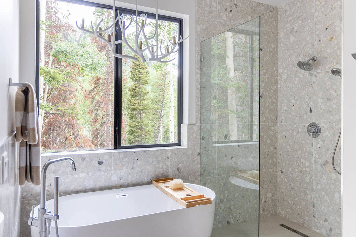 modern scandinavian style bathroom with a freestanding tub and glass shower