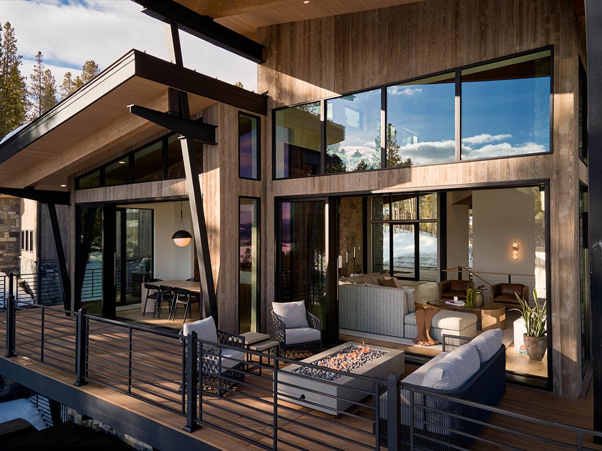 mountain contemporary exterior with a large deck and outdoor furniture