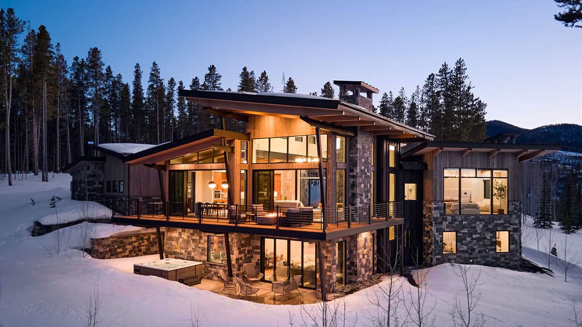 mountain contemporary home exterior with snow at dusk