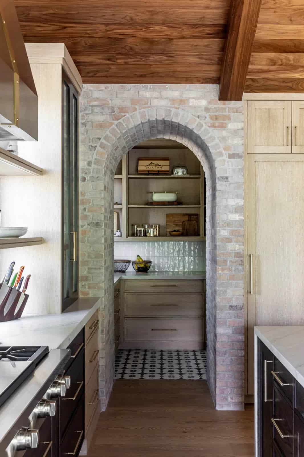 modern kitchen with an arch entry into the pantry