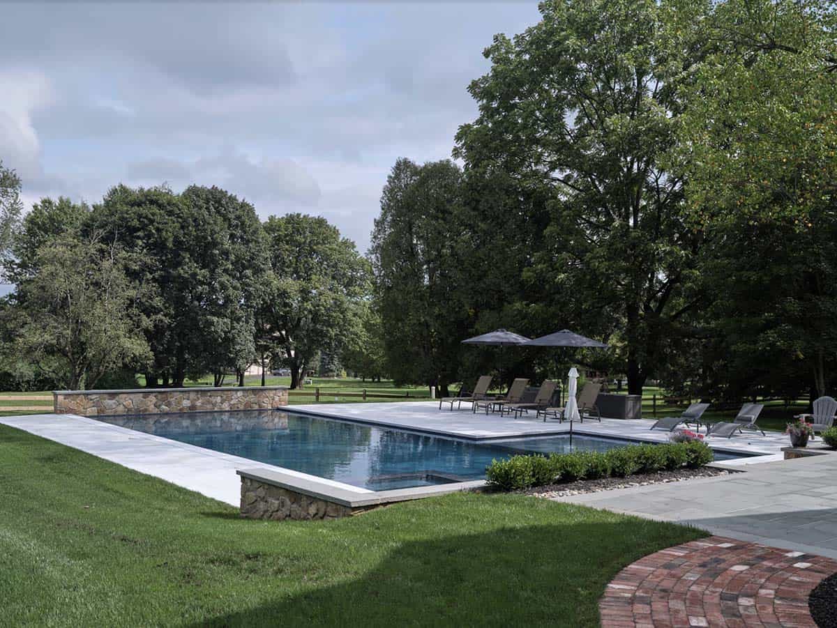 farmhouse home exterior with a pool