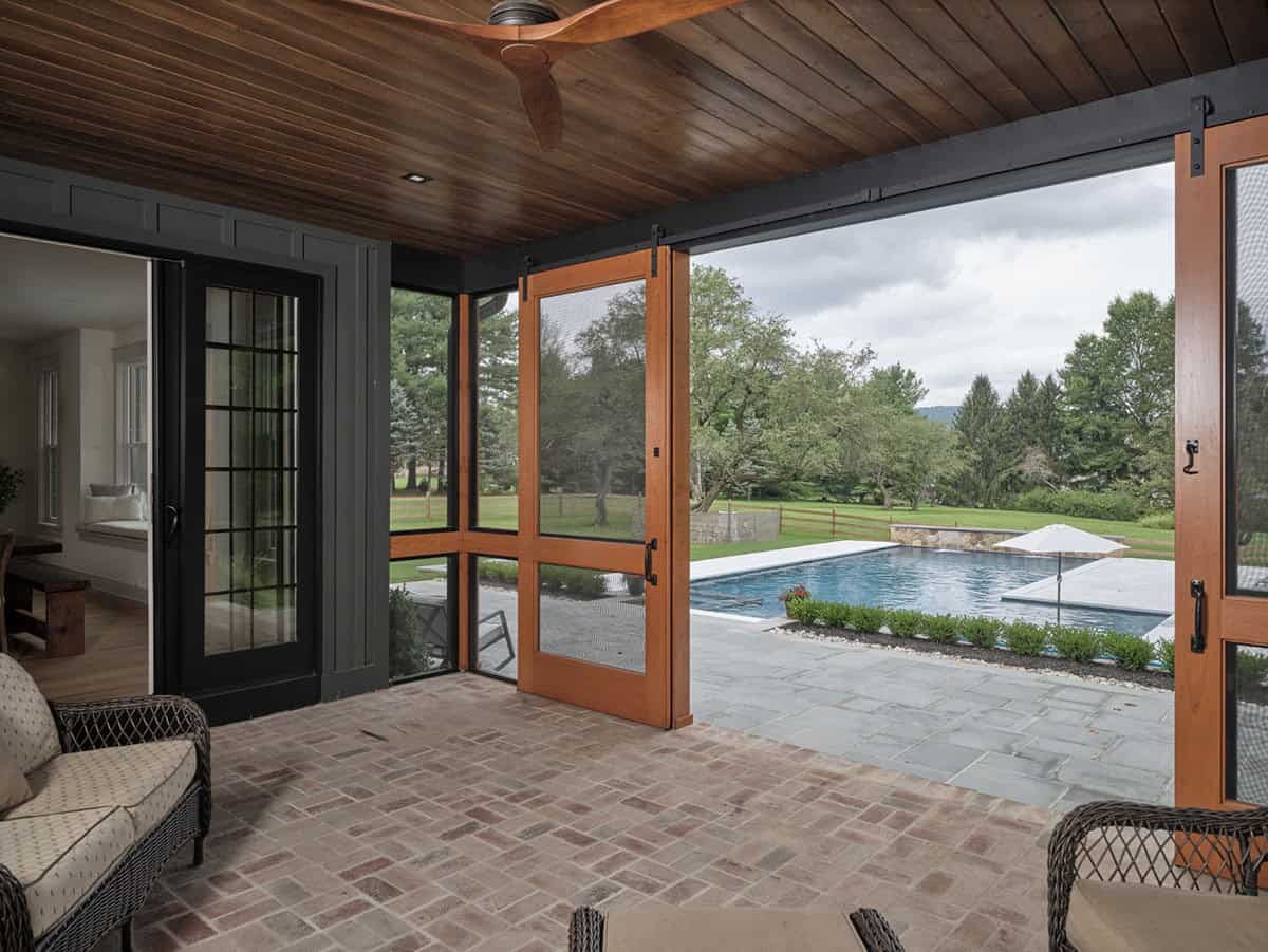 farmhouse style covered patio overlooking the pool