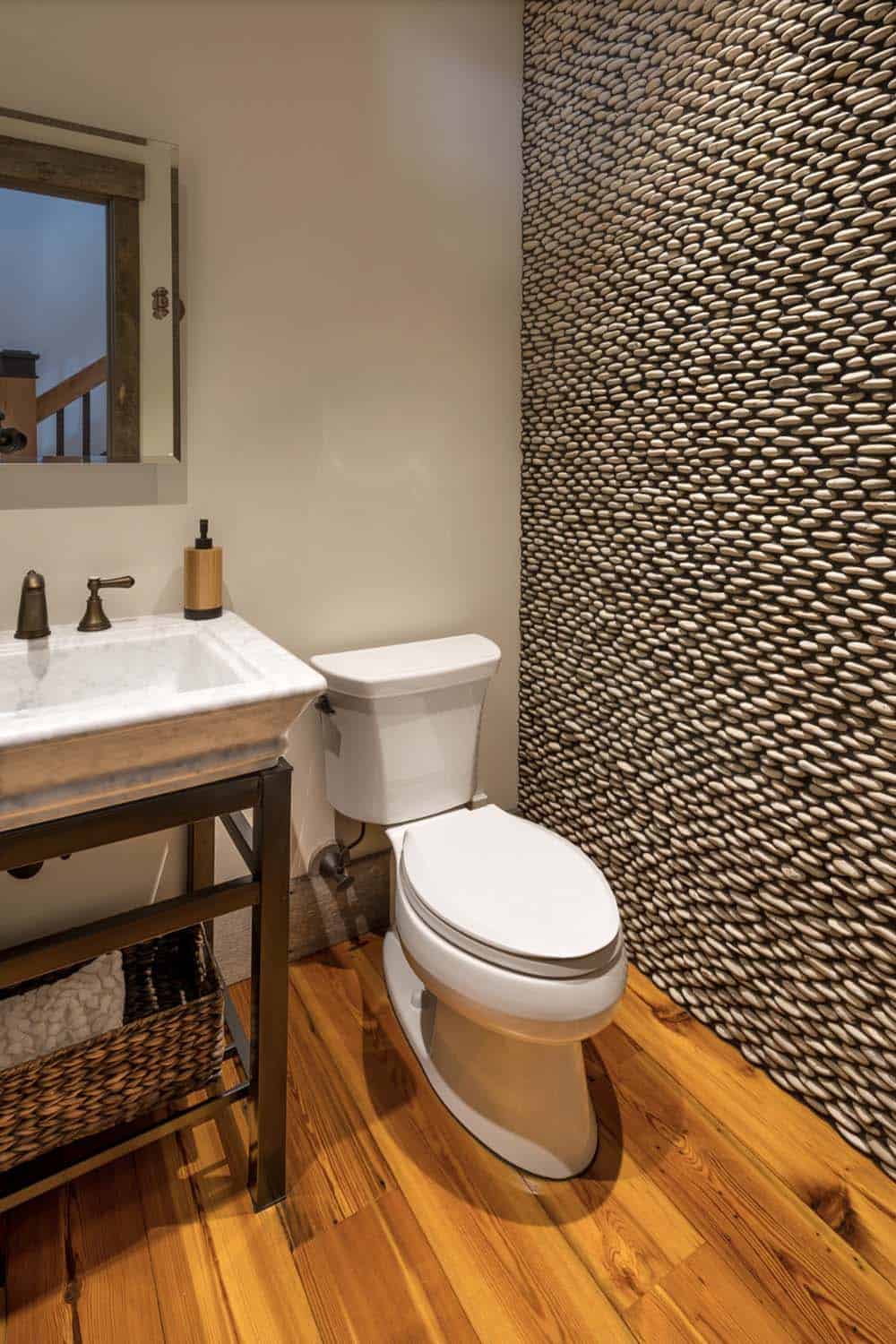 rustic bathroon with a stone accent wall