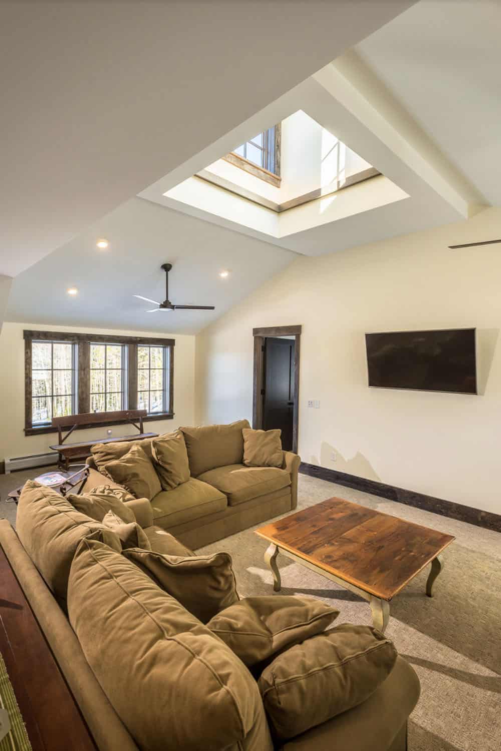 rustic family room with a skylight