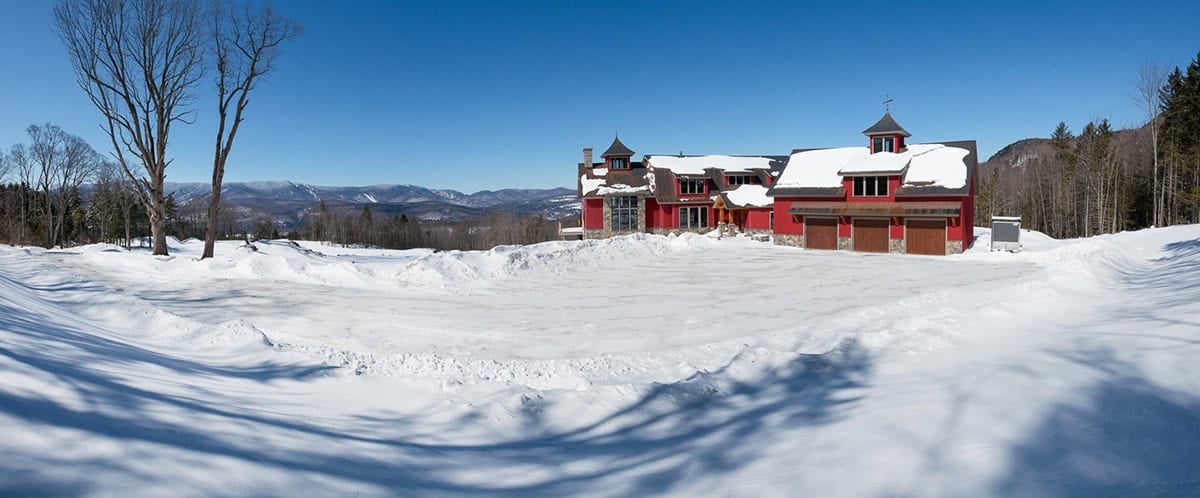rustic red farmhouse exterior with snow