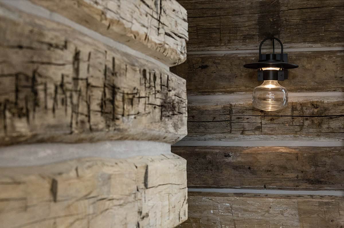 rustic hallway with a wal sconce