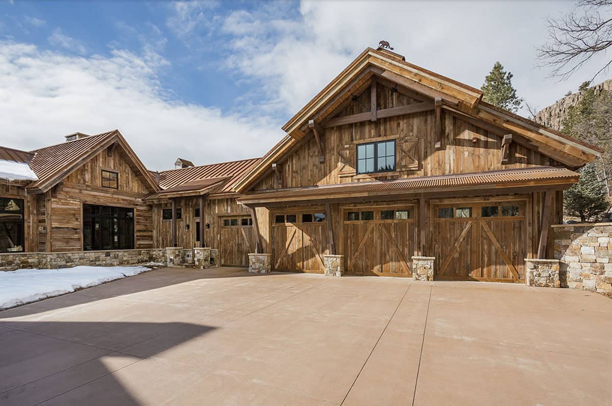 timber frame mountain house exterior with snow